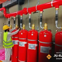 Technician standing in a room with fire suppression cylinders
